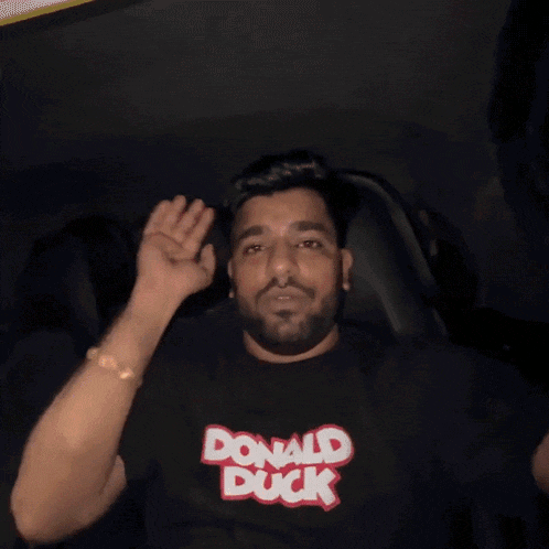 a man wearing a black shirt that says donald duck on it