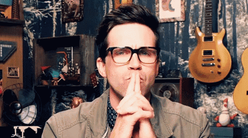 a man wearing glasses is making a silly face