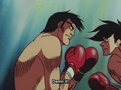 a man in boxing gloves says " damn it " in front of another man