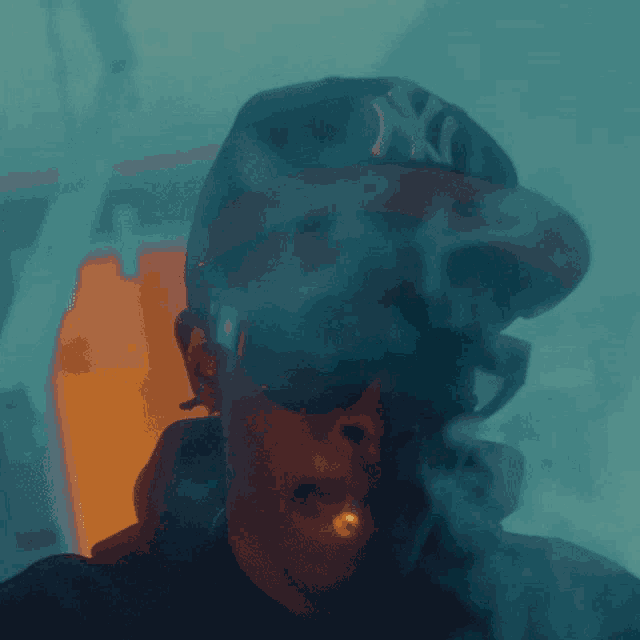 a man wearing sunglasses and a ny hat smoking a cigarette