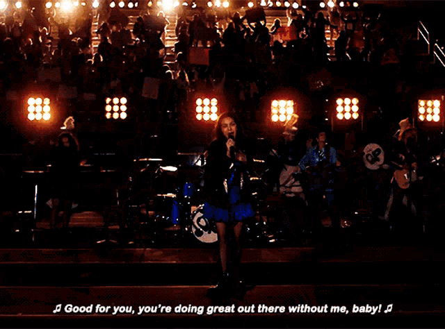 a woman singing into a microphone with the words " good for you you 're doing great out there without me baby ! "