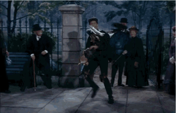 a man in a top hat is playing a drum