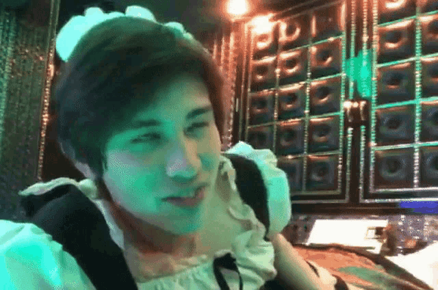 a man in a maid costume is looking at something