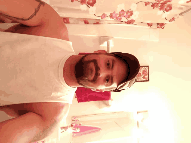 a man taking a selfie in front of a shower curtain