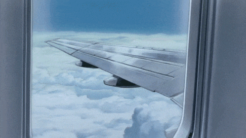 the wing of an airplane is visible through the window of an airplane