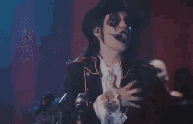 a man in a costume is standing in front of a microphone .