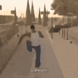 a man in a white shirt is walking down a street with trees in the background and the words @dreszin on the bottom