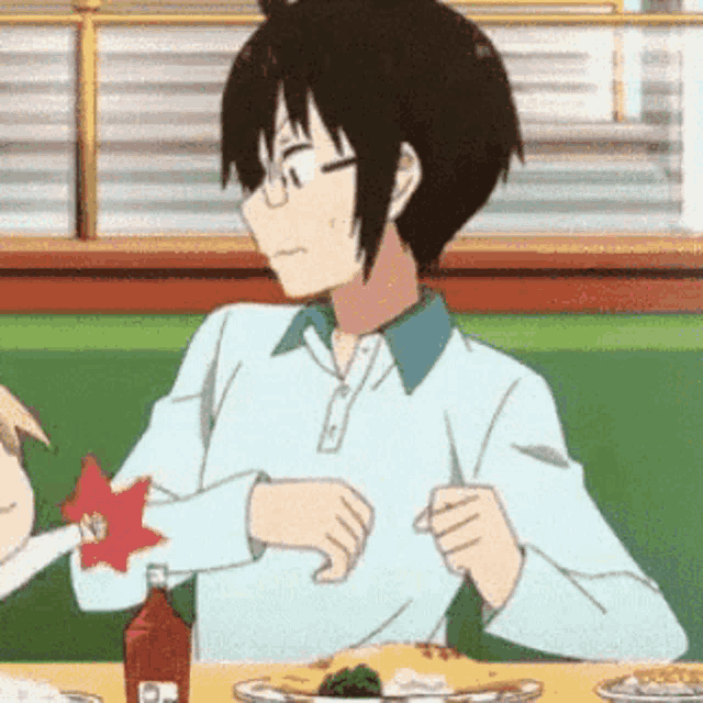a cartoon character is sitting at a table with a bottle of ketchup and a plate of food .
