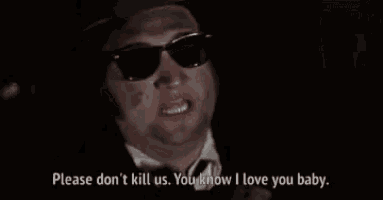 a man wearing sunglasses and a suit says please don 't kill us you know i love you baby