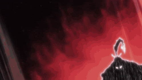 a silhouette of a person standing in front of a red background in a dark room .
