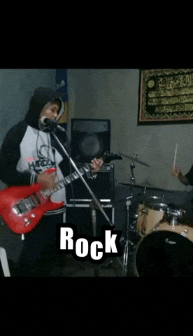 a man playing a guitar in front of a microphone with the word rock above him