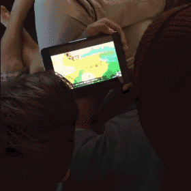 a person is playing a video game on a tablet that says animal crossing on the screen