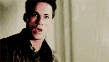 a close up of a man 's face with a surprised expression