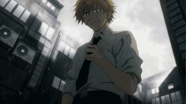 a man in a white shirt and black tie stands in front of buildings