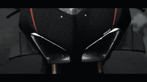 a close up of a ducati motorcycle with rain drops on it