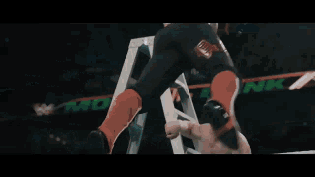 two wrestlers are fighting in a ring with a ladder in the background that says movie
