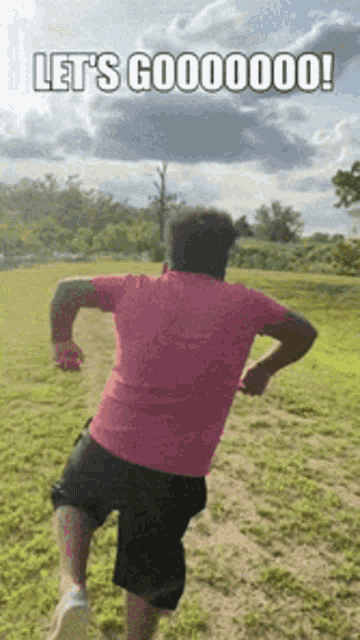 a man in a pink shirt and black shorts is running in a field with the words let 's go00000 written on the bottom