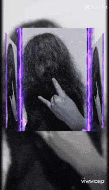 a black and white photo of a woman 's face with purple lights behind her