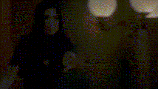 a blurred image of a woman 's face with a veil covering her head