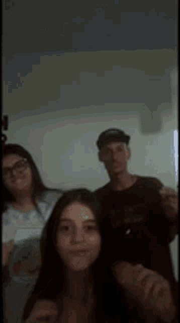 a group of people are posing for a picture in a room .