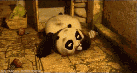 a panda bear is laying on its back on a tile floor