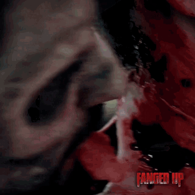a close up of a person 's face with the words fanged up on the bottom