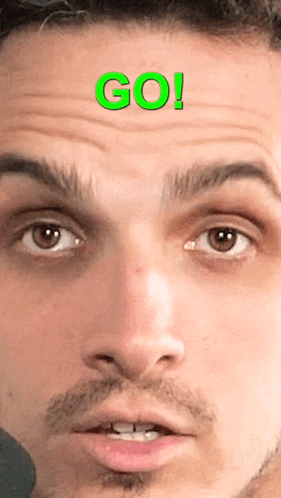 a close up of a man 's face with the word go written on his forehead