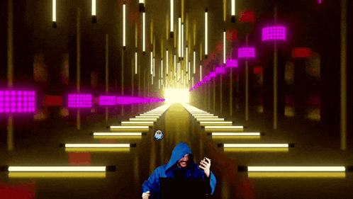 a man in a blue hooded jacket is playing a video game on a laptop
