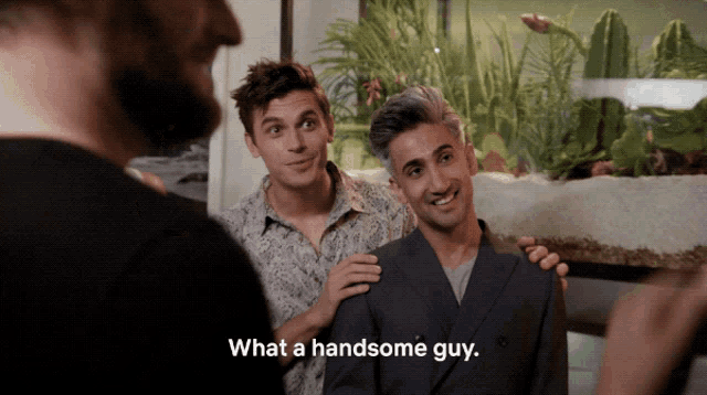 a man says what a handsome guy while standing next to another man