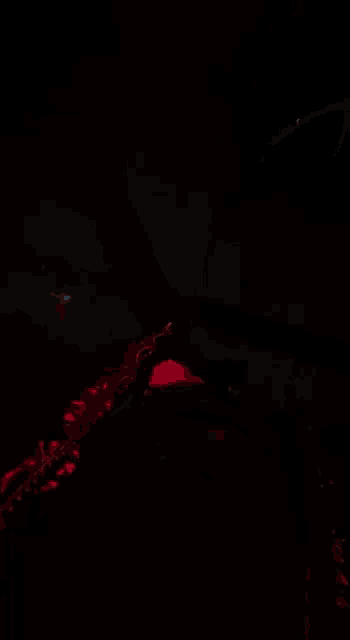 a blurred image of a dark room with a few lights on