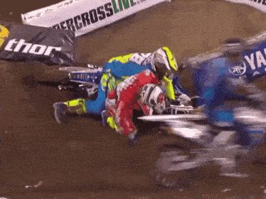 a person on a motorcycle is being helped by another person