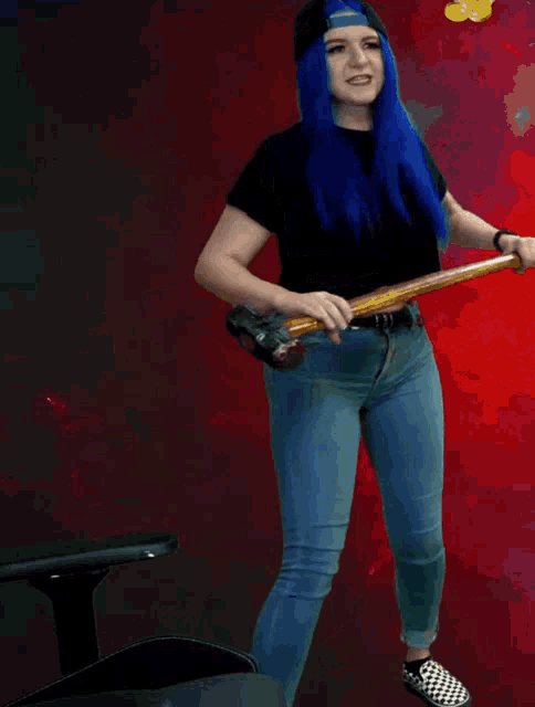 a woman with blue hair is holding a sword