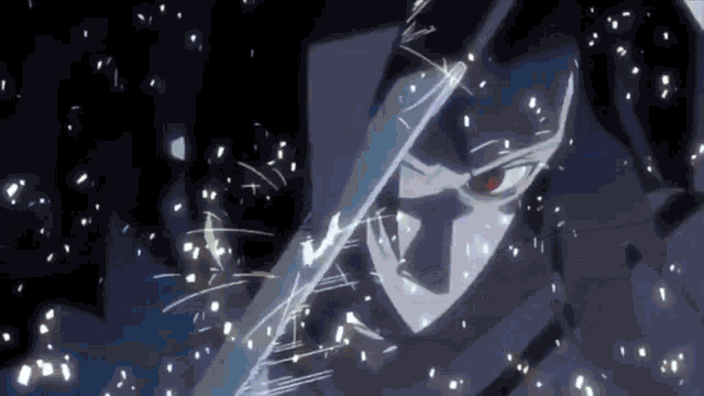 a close up of a person holding a sword in their hand in a dark room .