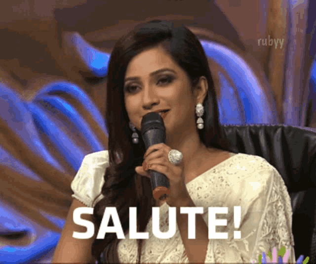a woman holding a microphone says salute
