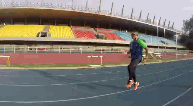 a man is jumping over hurdles on a track