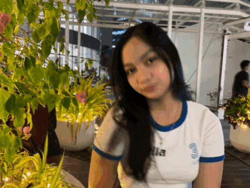 a girl wearing a white t-shirt with the word ella on the front
