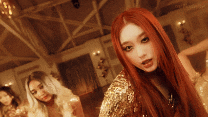 a woman with red hair is wearing a gold sequined outfit