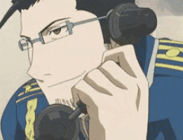 a man with glasses is holding a trombone in his hands .
