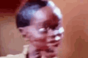 a close up of a person 's face with a blurred background