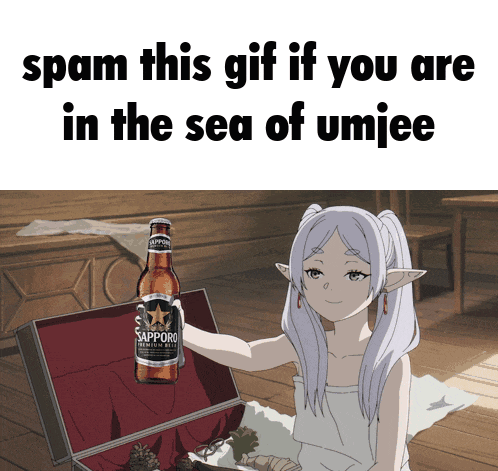 a girl holding a bottle of sapporo beer