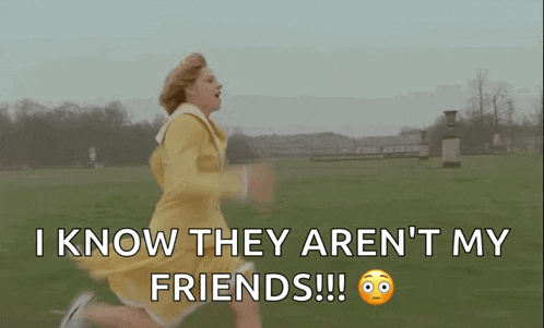 a woman in a yellow dress is running through a grassy field .