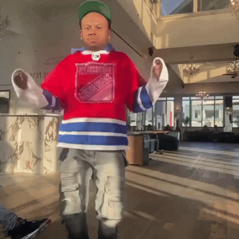 a man wearing a jersey that says montreal is dancing in a room