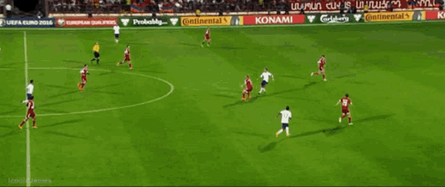 a soccer game is being played on a field with ads for konami adidas and carlsberg