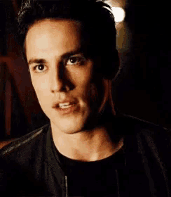 a close up of a man 's face with a dark background
