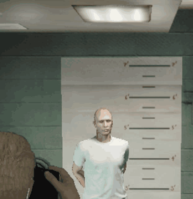 a man in a white shirt is standing in front of a ruler that shows his height at 7 inches