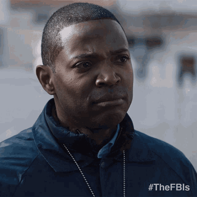 a man in a blue jacket with the hashtag #thefbls