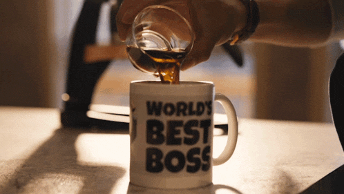 a person is pouring coffee into a mug that says " world 's best boss "