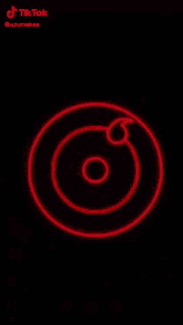 a red circle on a black background that looks like a hypnotic spiral