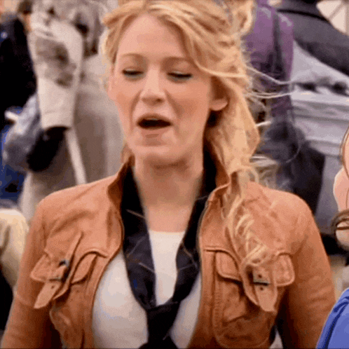 a woman wearing a brown leather jacket and a black tie