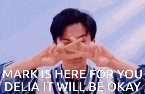 a man is making a peace sign with his hands in front of his face